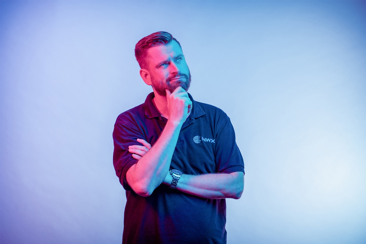 Man holds his hand to his chin, brooding