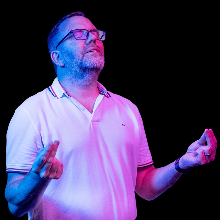 Man has his eyes closed and holds his hands in front of him 