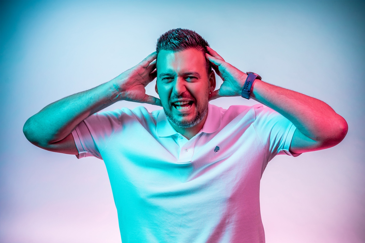 Man holds his hands to his head 