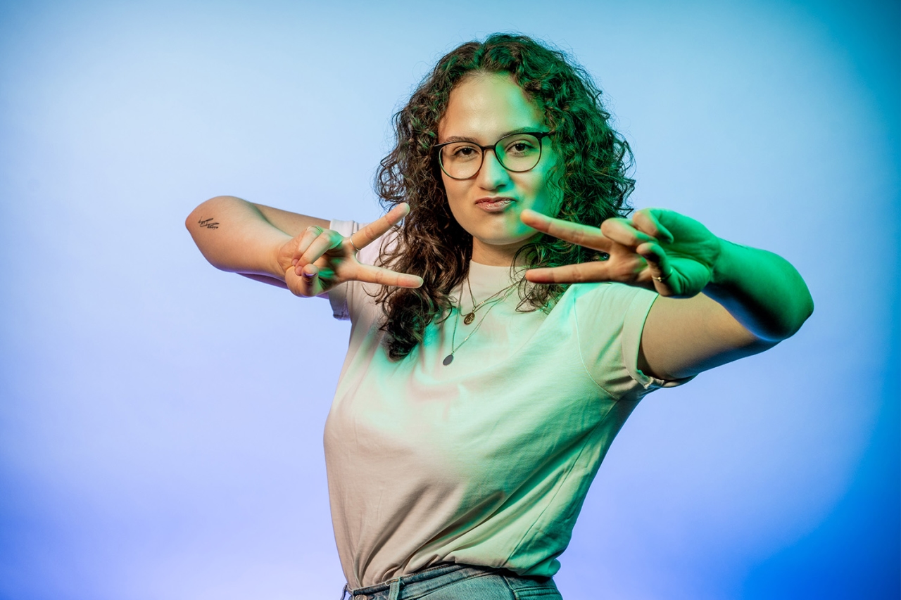 Woman shows peace sign with both hands