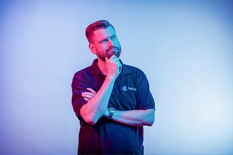 Man holds his hand to his chin, pondering