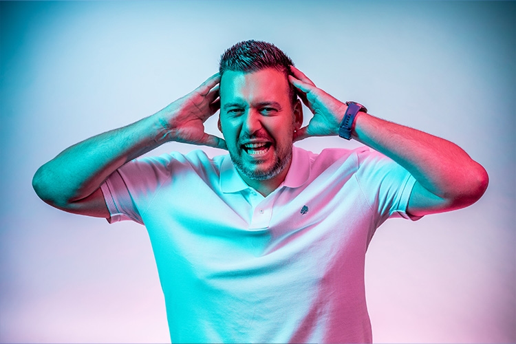 Man holds hands to head and screams