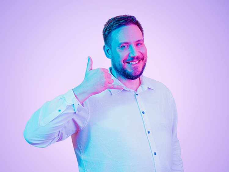 Man shows thumbs up and forms phone with the other hand