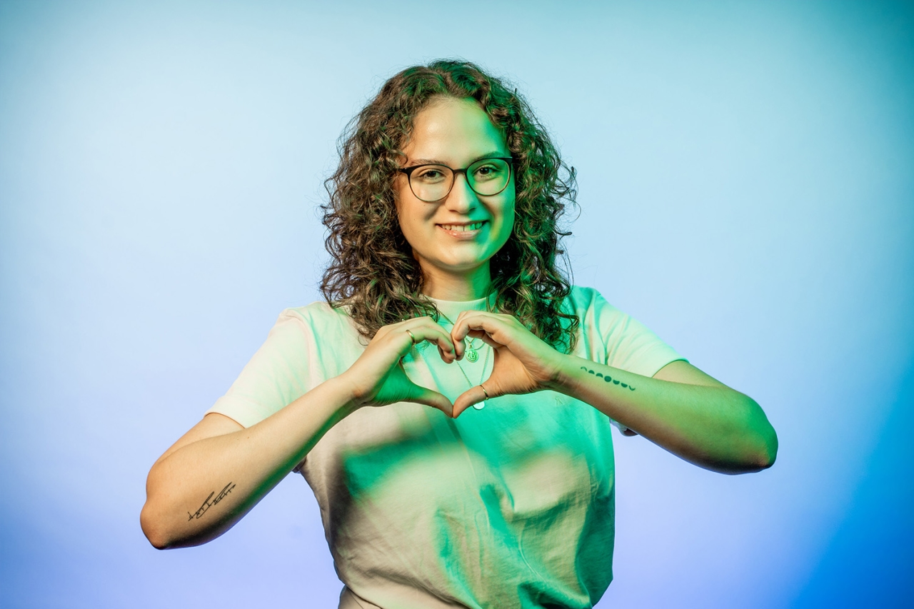 Woman forms heart with her hands